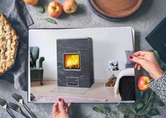 an open magazine with a pie, apples and other food on the table next to it