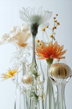 several glass vases with flowers in them