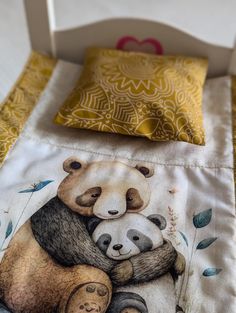 two panda bears hugging each other on a bed with yellow and white comforter covers