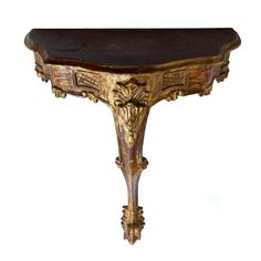 an ornate wooden table with carvings on the top and bottom, against a white background