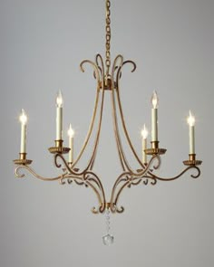 a chandelier with five candles hanging from it's center, and the words visual comfort above it