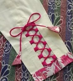 a piece of fabric with pink and white designs on it