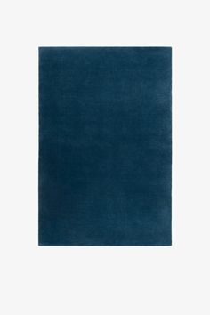 a dark blue rug on a white background with an empty space in the center for text