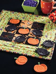 an advertisement for halloween decorations on a table with pumpkins and black cats in the center