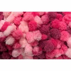 a pile of pink and red pom - poms