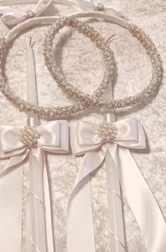 two wedding garters with bows and pearls on them