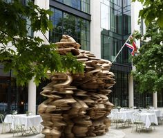 a large stack of clay sitting in front of a tall building