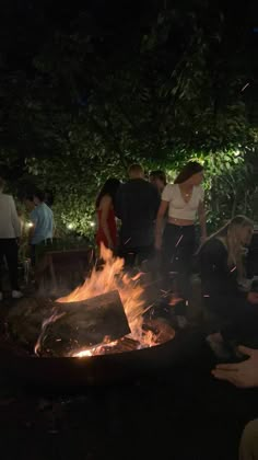 people are gathered around an outdoor fire pit