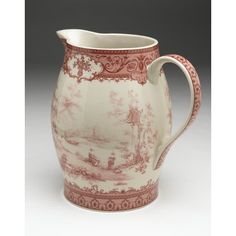 a red and white pitcher with a landscape on it