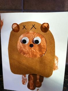 a brown bear with big eyes on it's face is made out of paper