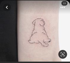 a small dog tattoo on the right side of the arm is shown in black ink