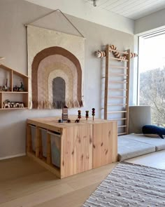 a living room with a couch, rug and wooden shelves in front of a window