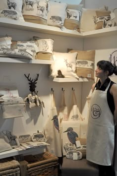 a woman standing in front of shelves filled with items