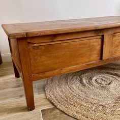 a wooden bench sitting on top of a rug