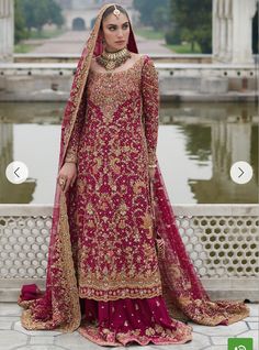 a woman in a red and gold bridal gown standing next to a chandelier