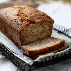 a loaf of bread sitting on top of a piece of paper next to a knife