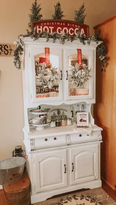 a white hutch with christmas decorations on top