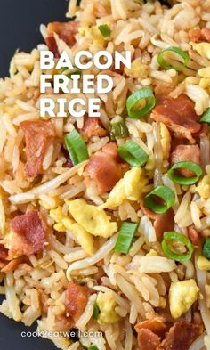 bacon fried rice in a black bowl with green onions on the side and text overlay that reads bacon fried rice