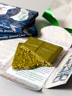 two pieces of green food sitting on top of a piece of paper next to each other