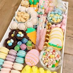 a tray filled with lots of different types of treats on top of a wooden table