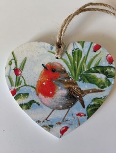 a heart shaped ornament with a bird on it