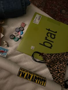 an assortment of items are laid out on a bed with the word i'm mantast written on it