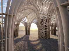 an intricately designed archway in the middle of a desert with sun shining through it