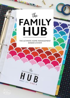 the family hub binder system is on top of a desk with scissors, pens and other office supplies