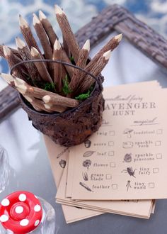 a glass table topped with lots of wooden sticks next to a red dot marker on top of paper