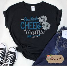 "Are you a Cheer Mom and proud of it? Get ready for the season with your very own shirt to wear to all the games! Ladies: Gildan Brand 6.0 oz., pre-shrunk 100% cotton Double-needle stitched neckline, bottom hem and sleeves Quarter-turned Taped neck & shoulders Seamless five-eighths inch collar Satin label Semi-Fitted (please note this is \"not\" a form fitting shirt) Unisex: Gildan Brand 6 oz, 100% cotton preshrunk jersey knit Seamless double-needle 7/8\" collar Satin label Taped neck and sh Cheerleader Tshirt Designs Ideas, Cheer Shirt Ideas, Mom Shirt Ideas, Cheer Mom Shirt, Cheer Mom Svg, Cheer Routines, Dance Team Gifts, Cheerleading Mom, Cheerleading Shirts