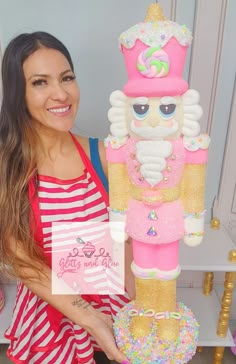 a woman standing next to a giant nutcracker