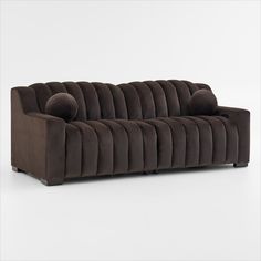 a brown couch sitting on top of a white floor