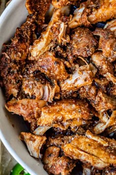 a white bowl filled with cooked chicken wings