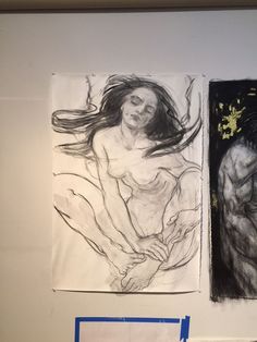 two drawings are hanging on the wall next to each other