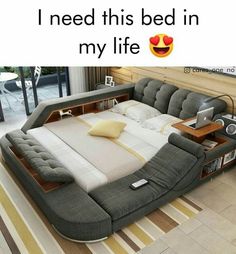 a bed that is in the middle of a room with a laptop on top of it