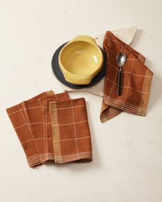 two napkins and a bowl on a table