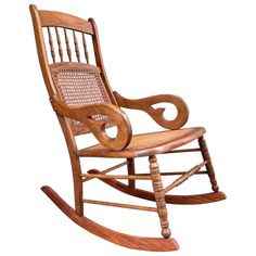 a wooden rocking chair with wicker seat and armrests on an isolated white background