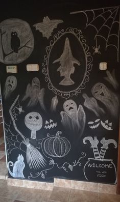 a chalk board with halloween drawings on it