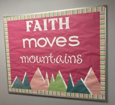 a bulletin board with the words faith moves mountains written in white letters on pink background