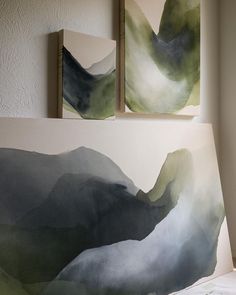 two paintings hanging on the wall next to each other