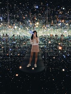 a woman taking a selfie in front of an array of lights