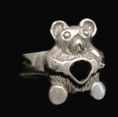 "A Vintage Sterling Silver Teddy Bear Holding a Heart Ring. The Ring is a Beautifully Crafted Functional Work of Jewelry. A Ring created around the 1970's. Size 7.75 Weight 3.7g Widest Part of Ring 5/8\" Thinnest Part of Band 1/8\" Rings are delivered in a Gift Box Free Domestic USA Shipping & Free Postal Insurance $5 Discount on International Shipping If you do not want the ring polished and want to leave the natural patina please let me know at the time of purchase as I do polish rings bef Bear Jewelry For Men, Bear Jewelry, Bear Ring Jewelry, Teddy Bear Necklace Jewelry, Teddy Bear Pendant, Friendship Rings, Love Ring, Vintage Sterling Silver, Heart Ring