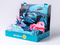 an open box with paper cut out of the ocean and marine animals on it's sides