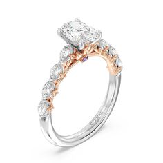 a diamond engagement ring with two tone gold and white diamonds