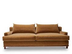 a brown couch with two pillows on it's back and one arm folded up