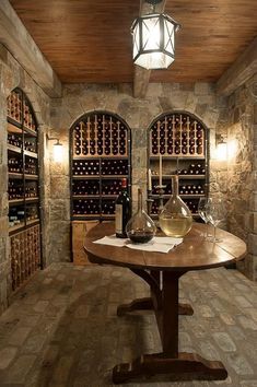 there is a wine cellar with bottles and glasses on the table in front of it