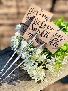 flowers are placed on top of each other with signs attached to them that read, let your love sparkle in the sun