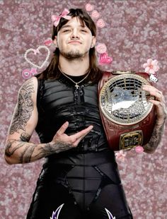 a man with tattoos holding a wrestling belt