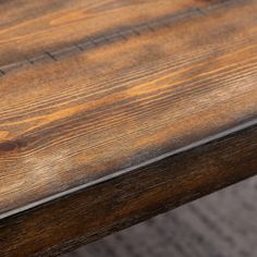 a close up view of a wooden table with metal trim on the top and bottom