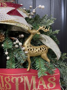 a christmas tree decorated with gold and silver ornaments